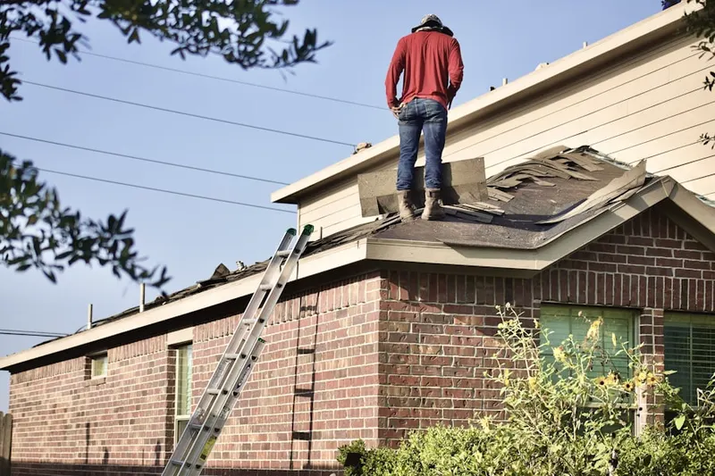 Professional roofer working on a residential roof in Olde Carlsbad